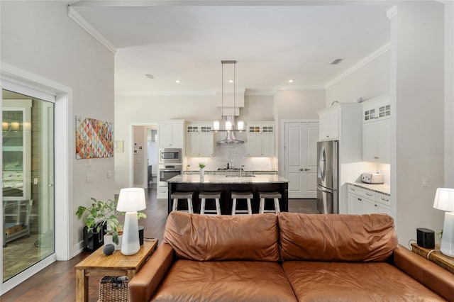 living area featuring crown molding, dark wood finished floors, and visible vents