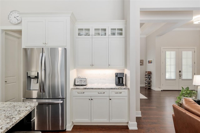 kitchen featuring dark wood-type flooring, light stone counters, white cabinets, and stainless steel fridge with ice dispenser