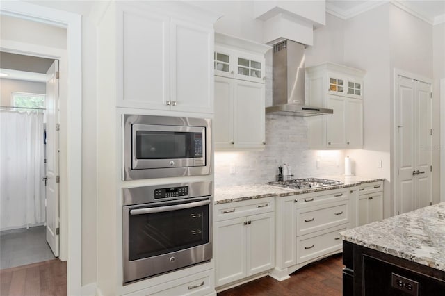 kitchen with wall chimney exhaust hood, backsplash, dark wood-style floors, and stainless steel appliances