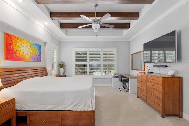 bedroom with multiple windows, a tray ceiling, and light colored carpet