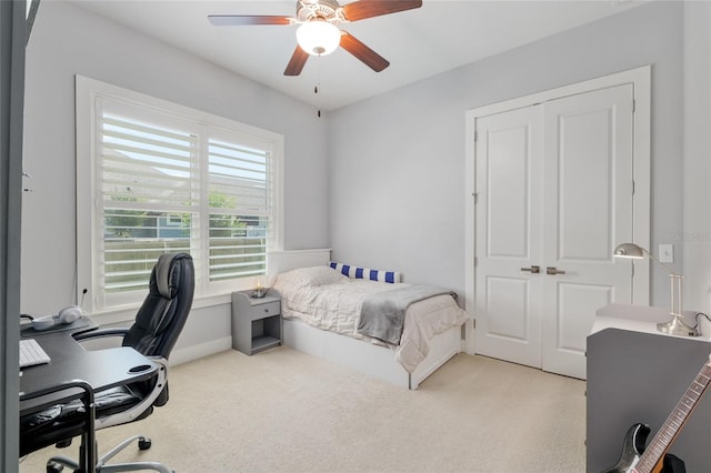 carpeted bedroom with a closet and ceiling fan