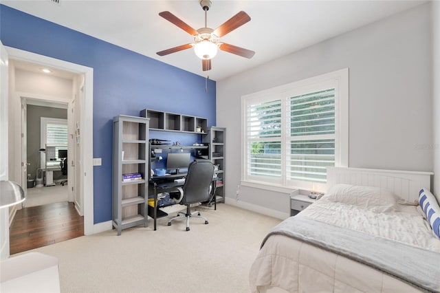 bedroom featuring baseboards, multiple windows, and carpet