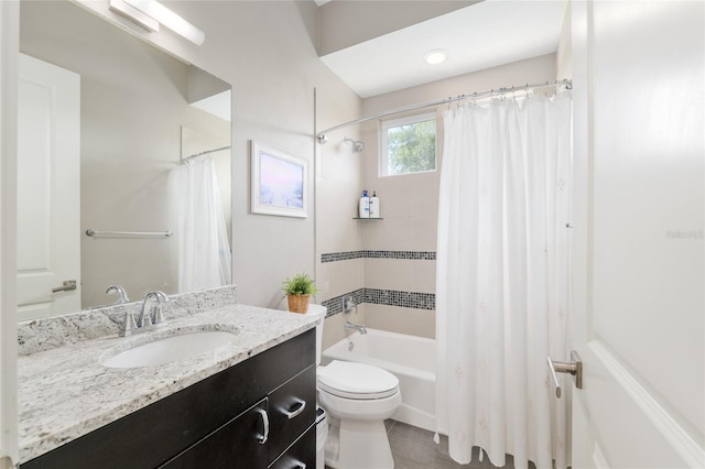 bathroom with vanity, shower / bathtub combination with curtain, and toilet