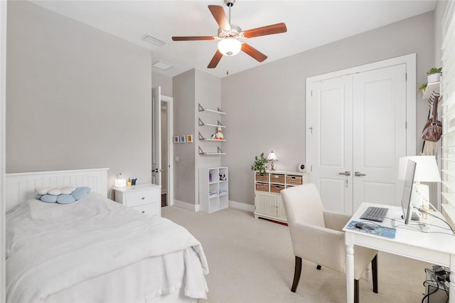bedroom with light colored carpet, a ceiling fan, baseboards, visible vents, and a closet