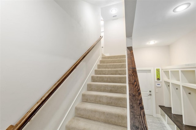 staircase with recessed lighting