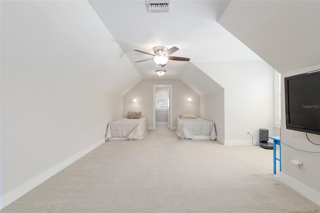 unfurnished bedroom with visible vents, lofted ceiling, baseboards, ceiling fan, and carpet
