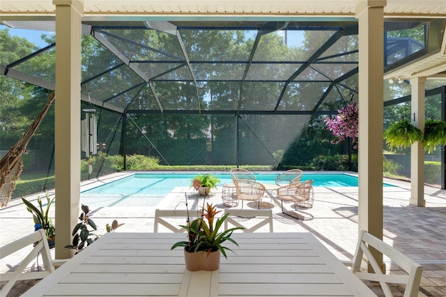 outdoor pool with a patio and glass enclosure