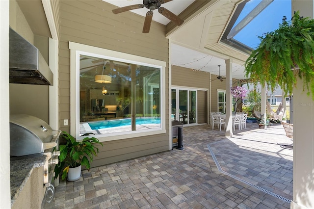 view of patio / terrace featuring an outdoor kitchen, a ceiling fan, outdoor dining space, and area for grilling