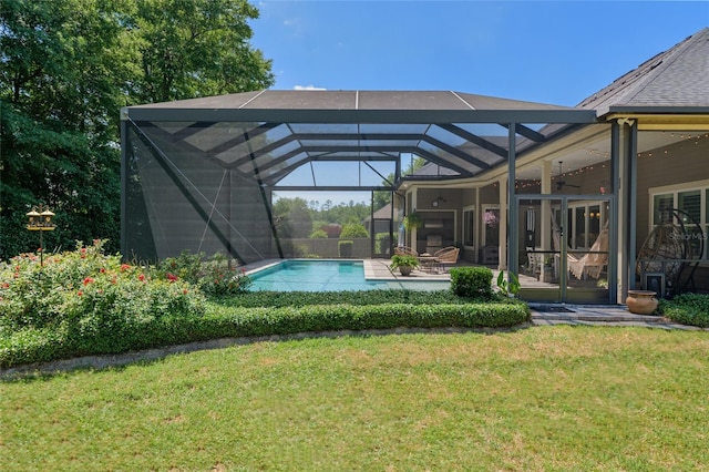 back of house with a lawn, a ceiling fan, a patio area, and an outdoor pool