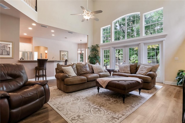 4515 SW 97th Ter, Gainesville, FL 32608 - living room with a towering ceiling, ceiling fan, wood finished floors, baseboards, and recessed lighting