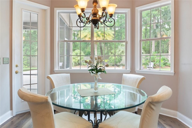 4515 SW 97th Ter, Gainesville, FL 32608 - dining room featuring a chandelier, baseboards, and plenty of natural light