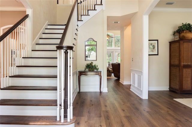 4515 SW 97th Ter, Gainesville, FL 32608 - stairs with wood finished floors, crown molding, a towering ceiling, and baseboards