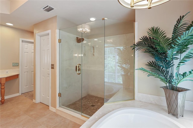4515 SW 97th Ter, Gainesville, FL 32608 - full bath with a stall shower, a bath, a chandelier, recessed lighting, and tile patterned flooring