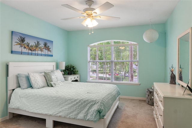 4515 SW 97th Ter, Gainesville, FL 32608 - bedroom featuring light carpet, baseboards, and a ceiling fan