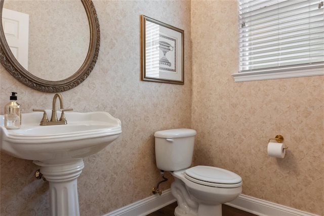 4515 SW 97th Ter, Gainesville, FL 32608 - bathroom with toilet, baseboards, and wood finished floors