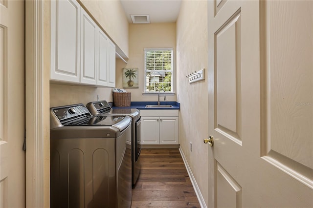 4515 SW 97th Ter, Gainesville, FL 32608 - laundry room with washer and dryer, dark wood-style flooring, cabinet space, and baseboards