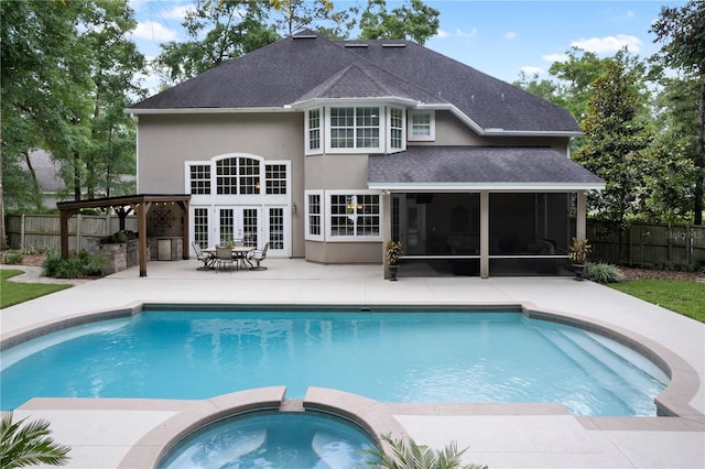 4515 SW 97th Ter, Gainesville, FL 32608 - view of pool featuring a patio area, a sunroom, fence, french doors, and a pool with connected hot tub