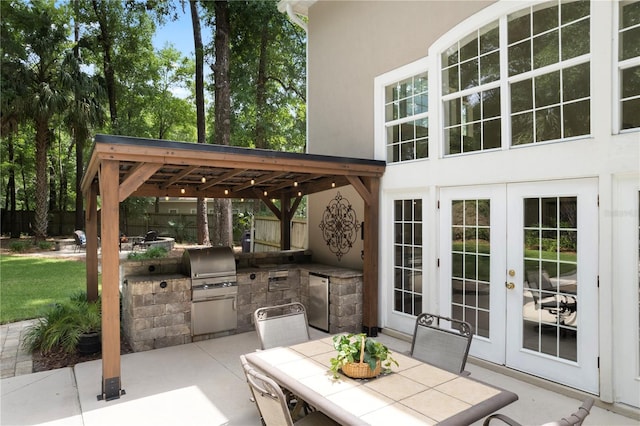 4515 SW 97th Ter, Gainesville, FL 32608 - view of patio / terrace with french doors, area for grilling, fence, and outdoor dining area