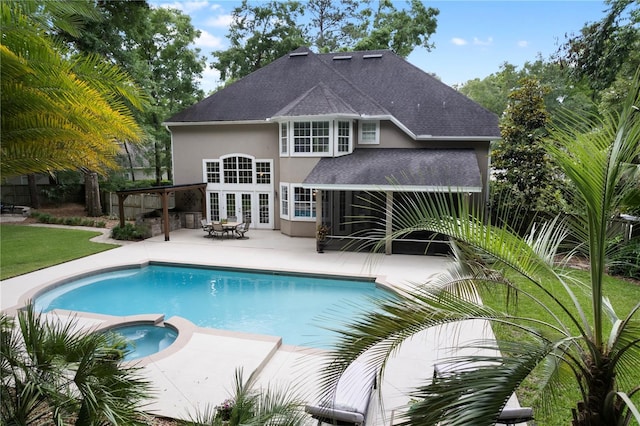 4515 SW 97th Ter, Gainesville, FL 32608 - view of pool featuring a patio area, a pool with connected hot tub, french doors, and a lawn
