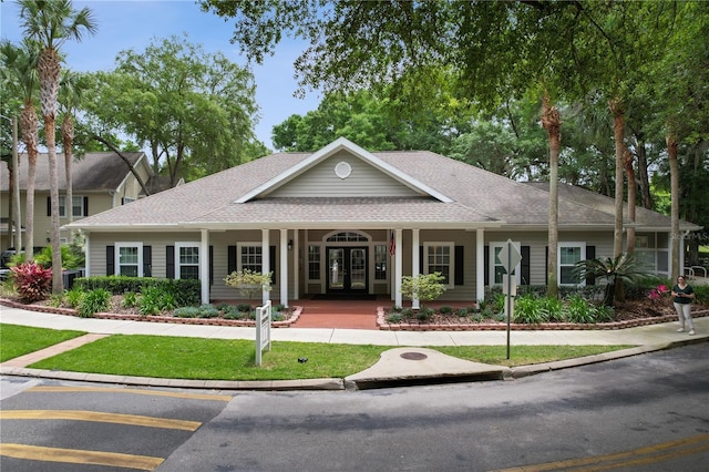 4515 SW 97th Ter, Gainesville, FL 32608 - view of front of home with a shingled roof, french doors, and a porch