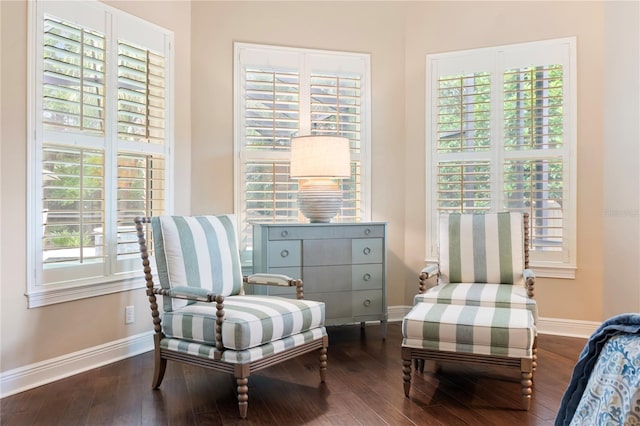 sitting room with baseboards, hardwood / wood-style floors, and healthy amount of natural light