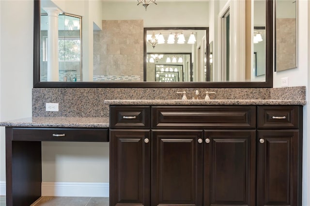 bathroom featuring vanity, tile patterned floors, and a chandelier