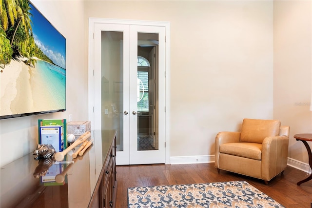 living area featuring french doors, wood finished floors, and baseboards