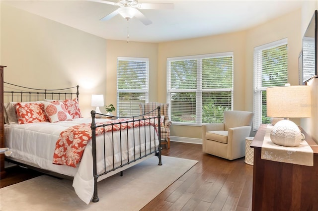 bedroom with wood finished floors, baseboards, and a ceiling fan