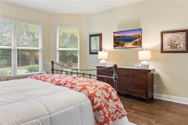 bedroom with wood finished floors and baseboards