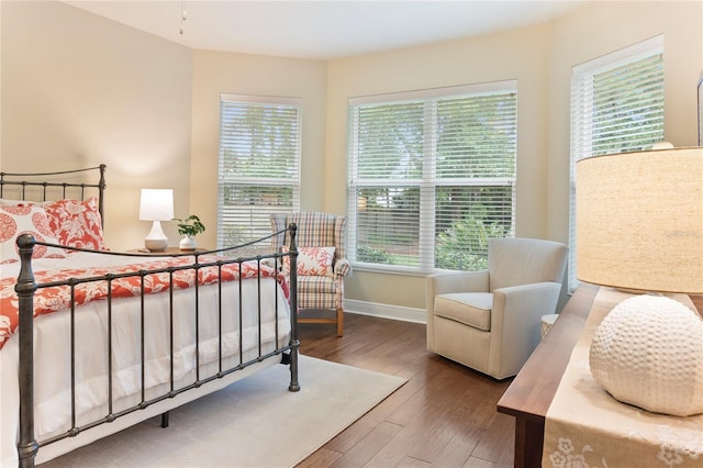bedroom with wood finished floors and baseboards