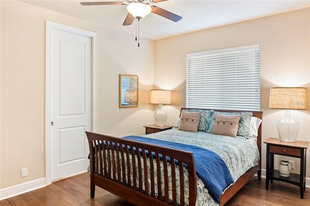 bedroom featuring wood finished floors, baseboards, and ceiling fan