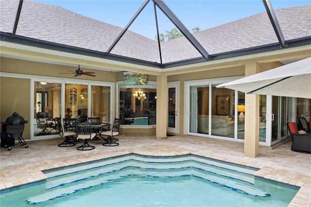 outdoor pool featuring ceiling fan, a patio, and a lanai