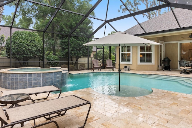 view of pool featuring a pool with connected hot tub, a patio area, a fenced backyard, and a lanai