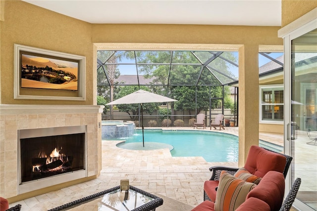 view of pool featuring a patio area, a pool with connected hot tub, and glass enclosure