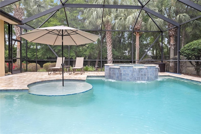 view of swimming pool featuring a patio, glass enclosure, and a pool with connected hot tub