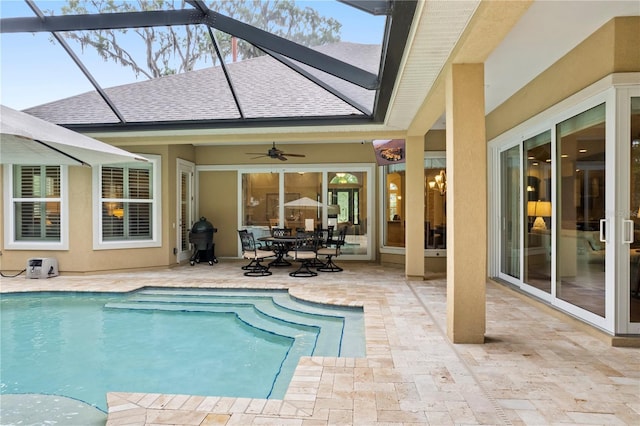 swimming pool with a patio, outdoor dining space, ceiling fan, a lanai, and grilling area