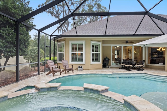 view of swimming pool with a pool with connected hot tub, a patio, a lanai, and fence