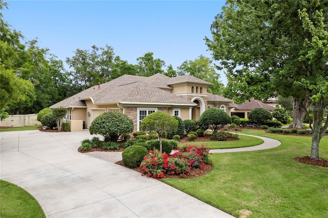 mediterranean / spanish-style home with driveway, stucco siding, and a garage