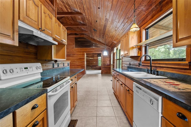 kitchen featuring wood walls, white appliances, wood ceiling, under cabinet range hood, and a sink