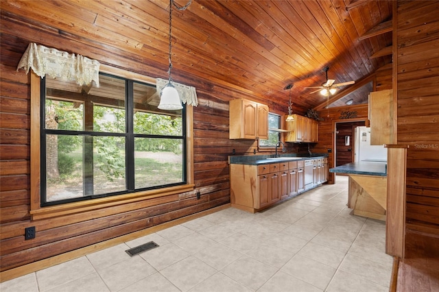 kitchen featuring visible vents, a sink, light tile patterned floors, and dark countertops