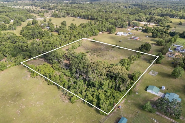 birds eye view of property with a view of trees
