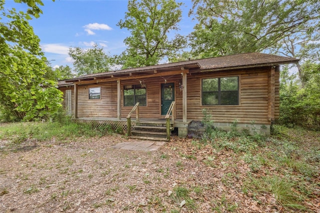 chalet / cabin featuring a porch and log siding