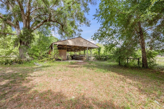 view of yard with an exterior structure, an outbuilding, and a carport