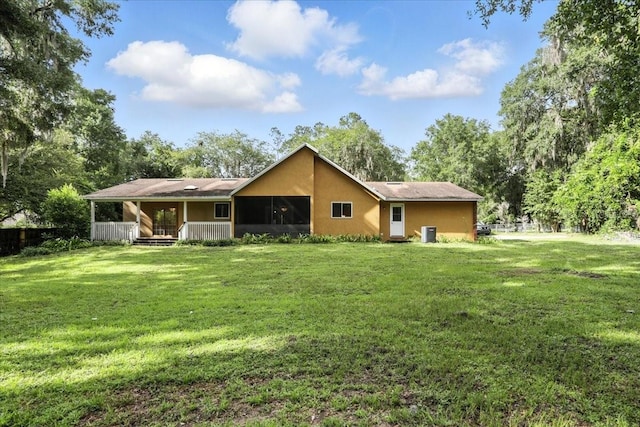 7800 SW 24th Ave, Gainesville, FL 32607 - back of house with a sunroom, a lawn, and stucco siding
