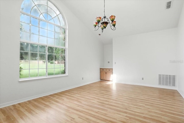 7800 SW 24th Ave, Gainesville, FL 32607 - unfurnished living room featuring high vaulted ceiling, a chandelier, and light wood-style floors