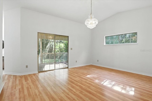 7800 SW 24th Ave, Gainesville, FL 32607 - unfurnished room with light wood-style flooring, a chandelier, and vaulted ceiling