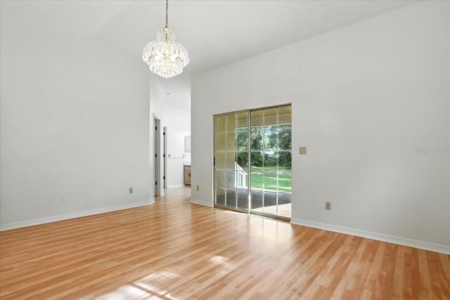 7800 SW 24th Ave, Gainesville, FL 32607 - spare room with a chandelier, light wood finished floors, and a high ceiling