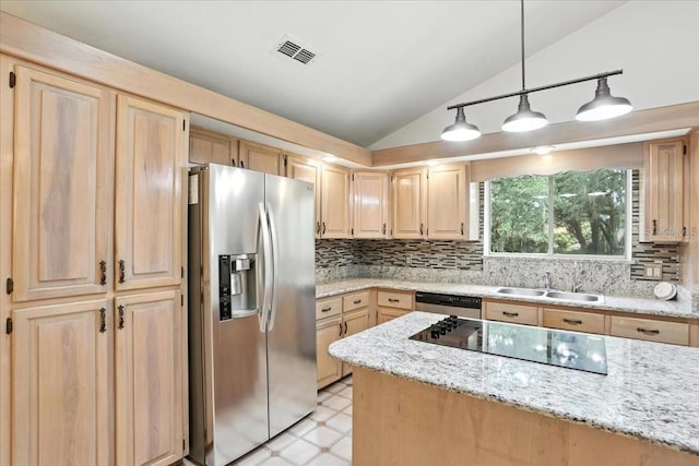 7800 SW 24th Ave, Gainesville, FL 32607 - kitchen featuring appliances with stainless steel finishes, lofted ceiling, light brown cabinets, light flooring, and decorative backsplash