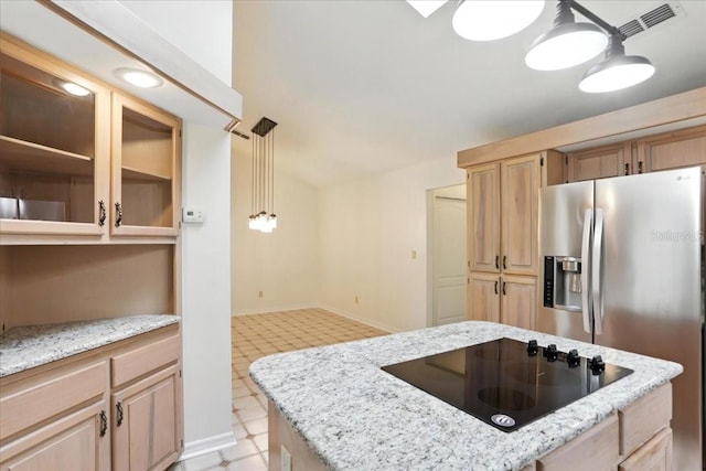 7800 SW 24th Ave, Gainesville, FL 32607 - kitchen with black electric cooktop, light flooring, stainless steel fridge, and light brown cabinetry