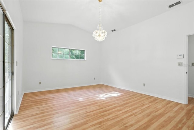 7800 SW 24th Ave, Gainesville, FL 32607 - spare room with light wood-style floors, a chandelier, and vaulted ceiling